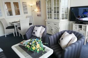 Wohnzimmer mit Sessel und TV