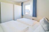 Schlafzimmer mit Doppelbett und Kleiderschrank 