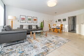 Wohnzimmer mit Sofa, Sessel und Essplatz